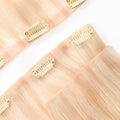 Close up of Celestial Beach Blonde clip in hair extensions seamless band construction
