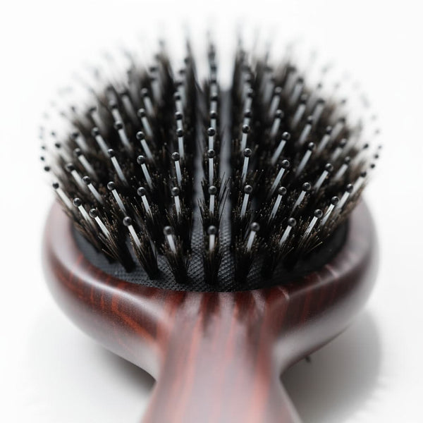 Macro view of extension-safe bristles and cushioned base on 7th Heaven hair extensions brush