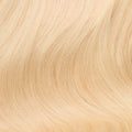 Close-up swatch of luminescent light golden blonde human hair clip-in extensions showing tone and texture