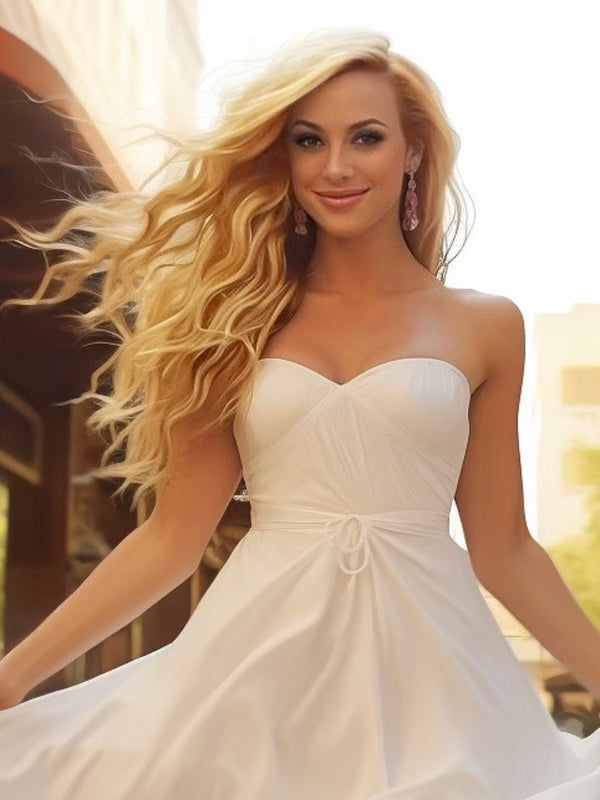 Model showcasing Radiant Rooted Ashy Blonde clip-in hair extensions from Seventh Heaven, styled in soft waves for a natural, sun-kissed look in a beautiful outdoor setting.
