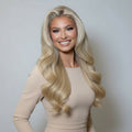 Model wearing 20 inch Rooted Creamy Beach Blonde clip-in hair extensions with long blended waves
