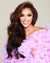Model showcasing rich brunette Seventh Heaven Hair Extensions in a voluminous style