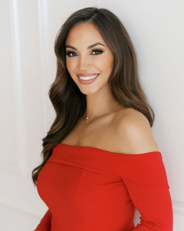 Maria Montgomery wearing luxury brunette clip-in hair extensions with soft glamorous waves and camera-ready volume