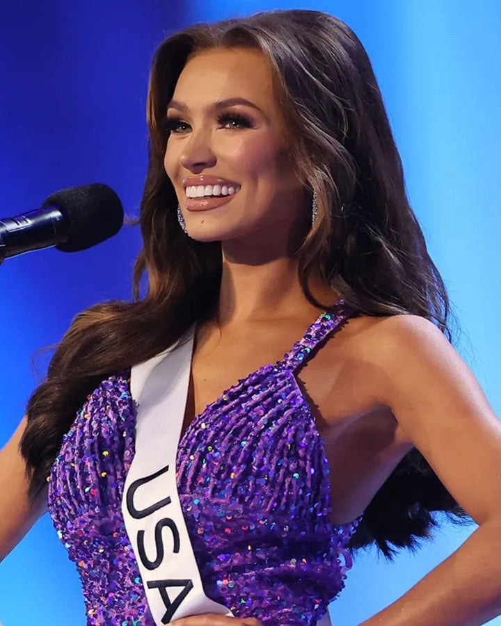 Miss USA 2023 Noelia Voigt smiling on stage with long brunette hair styled with Seventh Heaven hair extensions