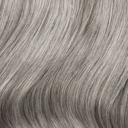 Close-up swatch of Sacred Salt & Pepper clip-in hair extensions showing silver and charcoal color blend