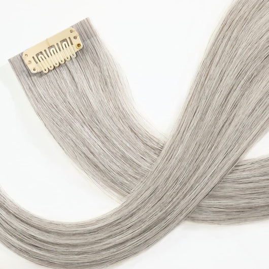 Close-up of secure clip attachment on icy salt and pepper clip-in hair extensions