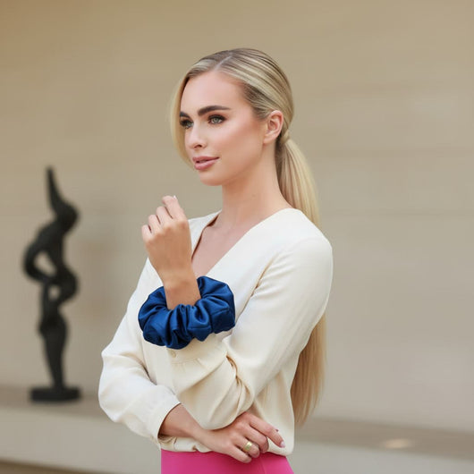 Oversized blue mulberry silk scrunchie worn on wrist to show size and volume