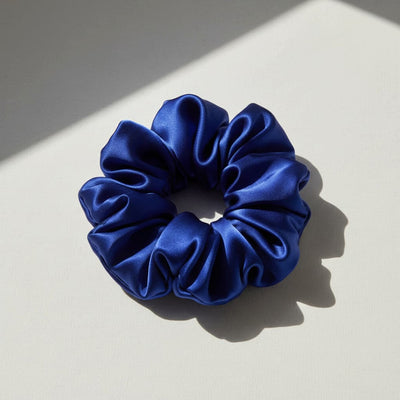 Oversized blue mulberry silk scrunchie with soft sculptural folds, luxury hair accessory