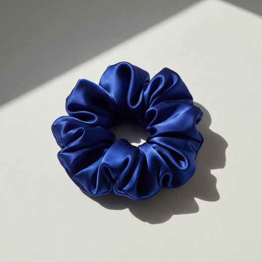 Oversized blue mulberry silk scrunchie with soft sculptural folds, luxury hair accessory