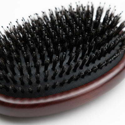 Close-up of cushioned base and dense bristle layout on 7th Heaven hair extensions brush
