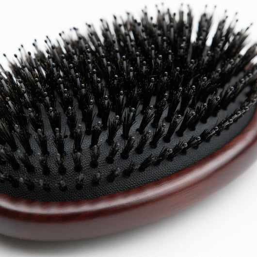 Close-up of cushioned base and dense bristle layout on 7th Heaven hair extensions brush