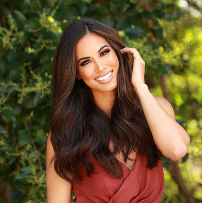 Model wearing 16 inch Decadent Chocolate Brown clip-in hair extensions with soft waves and natural shine