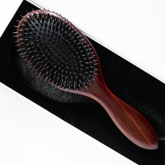 Model using the Beechwood Extension Brush to detangle and style Decadent Chocolate Brown hair extensions from Seventh Heaven.