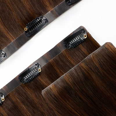 Close-up of clip-in hair extension band in Golden Chocolate Brown showing durable stitched weft