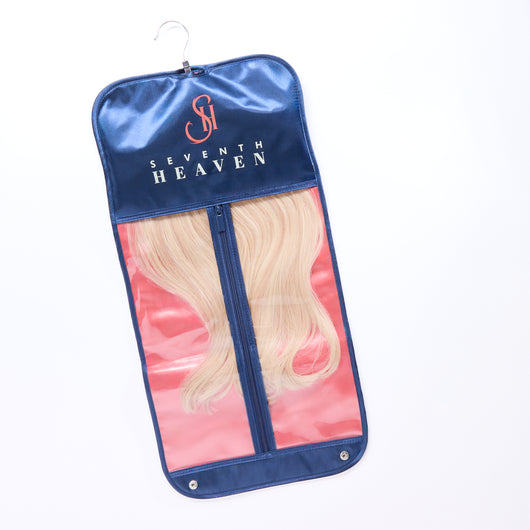 Venetian Vertical Satin Hair Extension Hanger Bag hanging neatly on a door. Elegant and practical for home or salon organization.