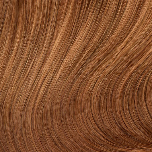 Close-up swatch of Majestic Ginger clip in hair extensions showing warm copper tone and silky texture