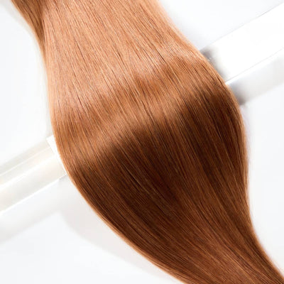 Close-up of Majestic Ginger clip in hair extensions showing smooth, flowing strands and warm copper shine