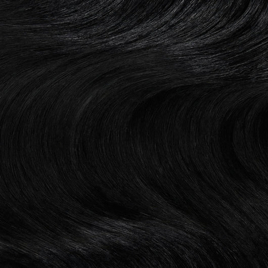 Close up swatch of Midnight Mystique black clip in hair extensions showing rich jet black color and silky texture