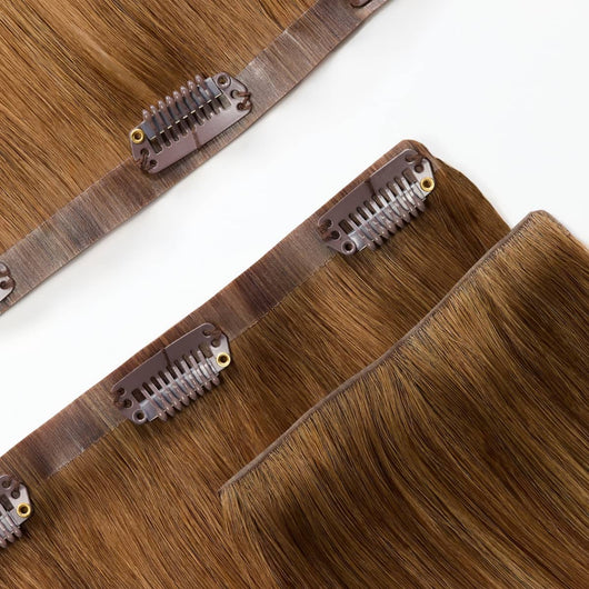 Close-up of reinforced band on rooted dark sandy bronde clip-in hair extensions