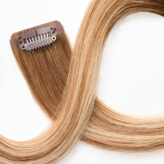 Close-up of secure clip attachment on rooted dark sandy bronde clip-in hair extensions