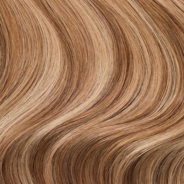 Close-up swatch of rooted dark sandy bronde shade from 7th Heaven clip-in hair extensions
