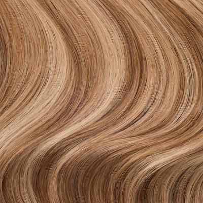 Close-up swatch of rooted dark sandy bronde shade from 7th Heaven clip-in hair extensions