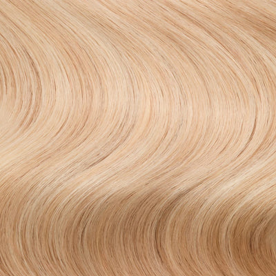 Close-up swatch of Rooted Creamy Beach Blonde clip-in hair extensions showing rooted blonde and creamy highlights