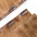 Close-up of Rooted Creamy Beach Blonde clip-in hair extension band with reinforced stitching and premium weft