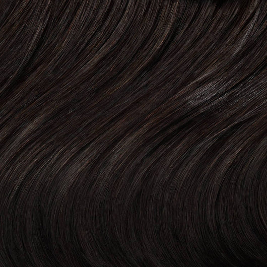 Close-up swatch of Sophisticated Natural Black clip in hair extensions showing rich tone and silky texture